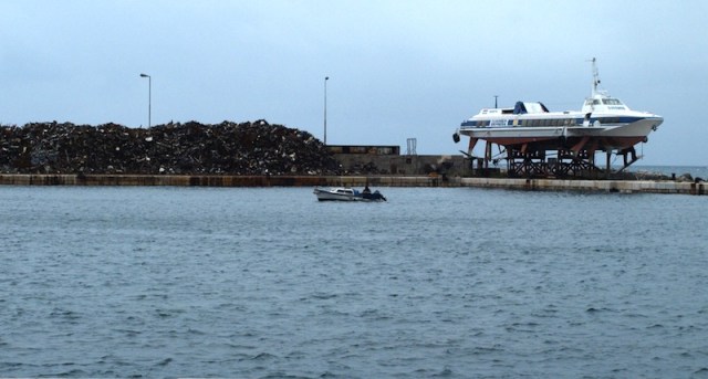 The stockpile to the left of the hydrofoil ferry is scrap metal. 