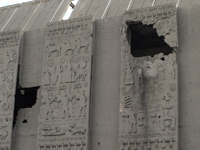Shell hole in a shopping complex wall. 