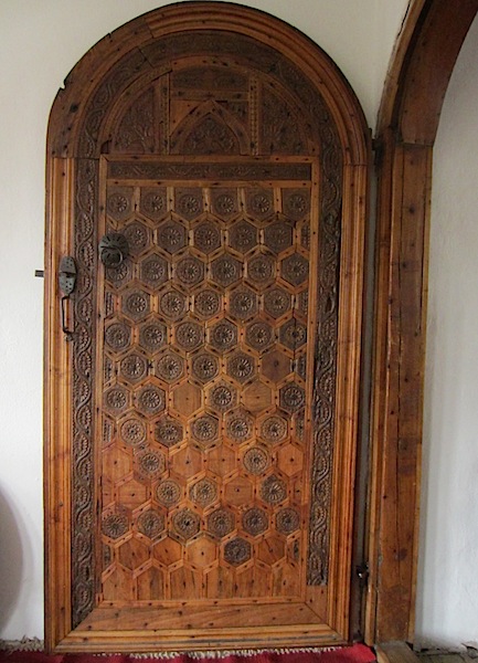 Intricate wooden door opening into the lounge area. 