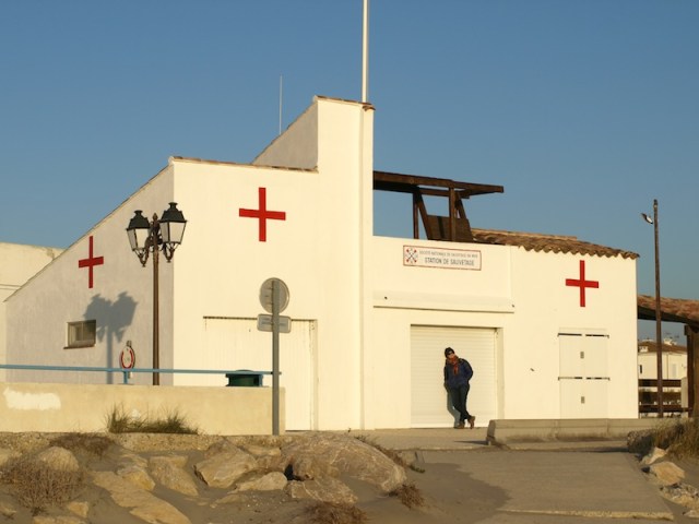 Bev taking advantage of the afternoon sun outside the beach first aid station. 