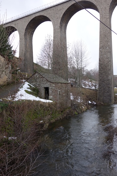 The viaduct, towering over the village and rivulet. 