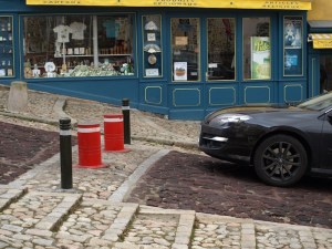 Hydraulic barrier posts. Punch in the correct pin number and the red hydraulic barrier posts go down into the road allowing vehicles to pass through. 