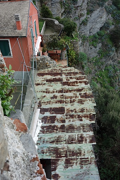 The corrugated iron roof of a café hewn out of the cliff face. 