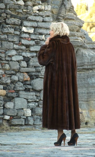 A stylish tourist admiring another piece of rock art.