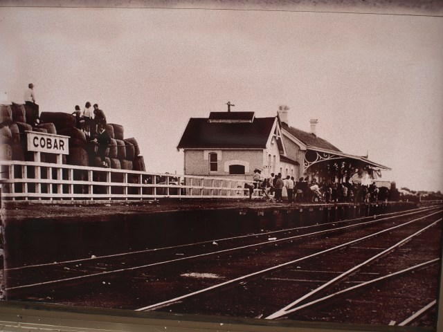 Wool bales at Cobar railway station being readied to be loaded onto a train. 