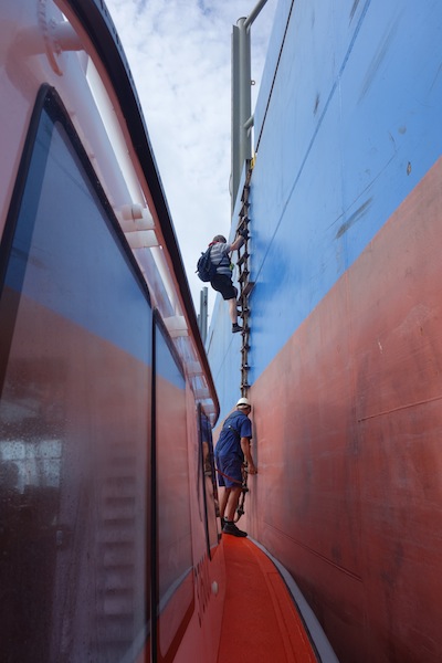 Pilot coming down. It is interesting to note that the pilots do not use a safety harness, preferring to take control of their own destiny rather than having a crew member above belaying them. 