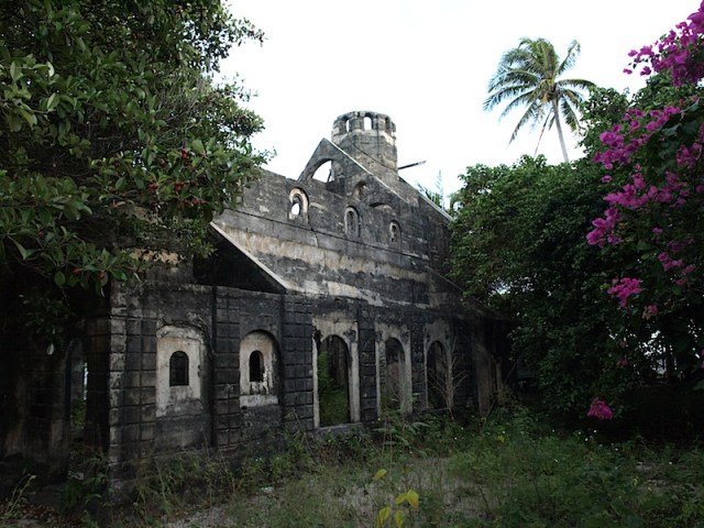 The Poruma (Coconut Island) Church of St Andrews. The foundation stone was laid in 1926 and the building reached bell tower stage before construction ceased.