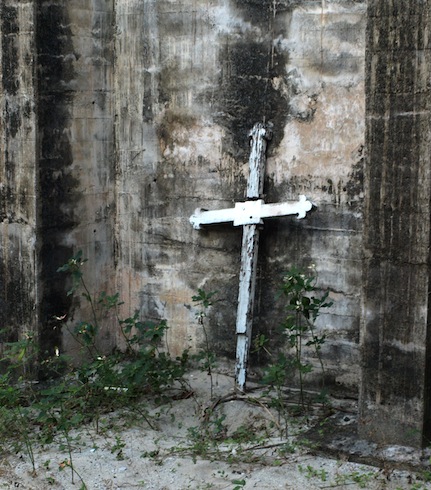 A cross standing guard in the ruins of St Andrews.
