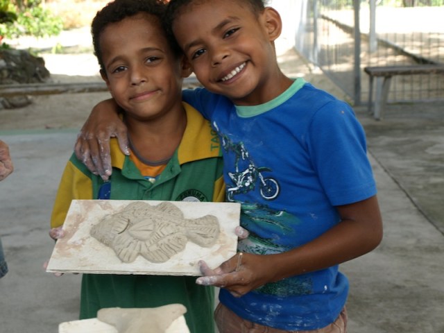 Two of the local schoolboys with a fish they made. 
