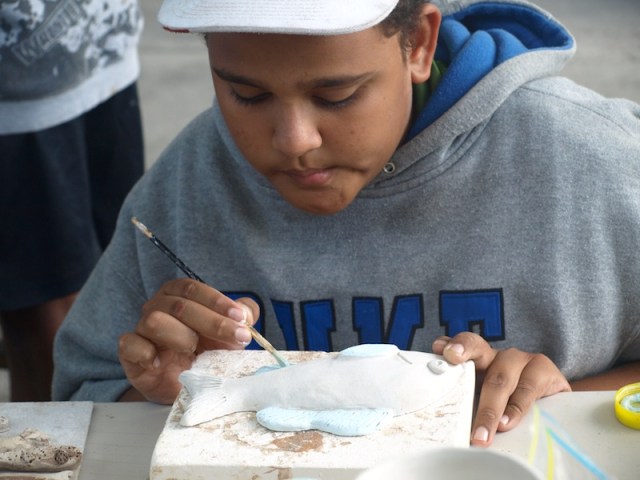 Cedric decorating his fish. 