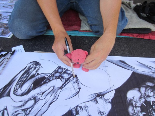 James teaching Tbear how to handle the pen. James told me that he has tried many different types of pens but the best for the job is the common old biro.
