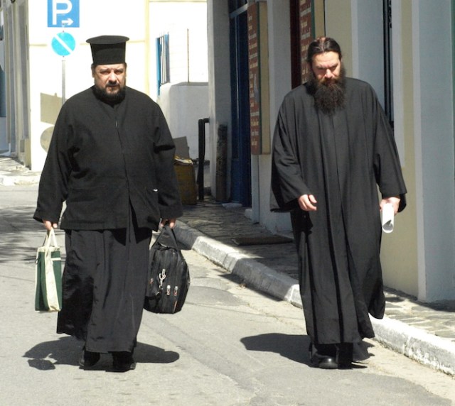 Greek Orthodox priests going home for lunch after a hard morning in the office. 
