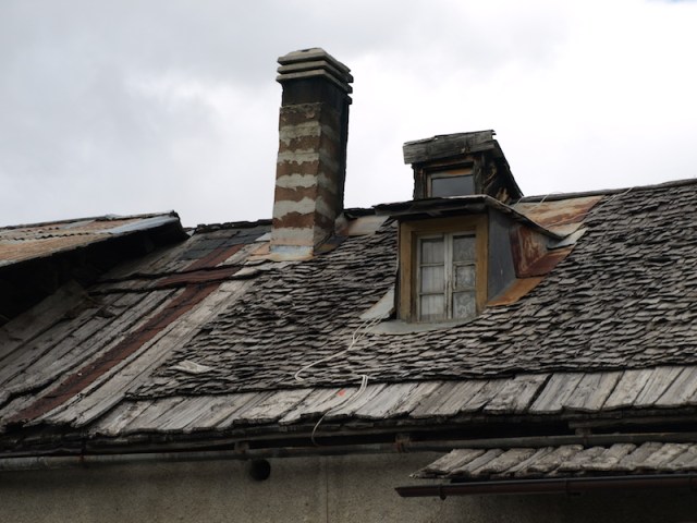 Farmhouse roof. Of interest is the combination of wooden planks and shingles. 