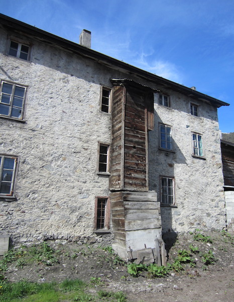 A garderobe (toilet) attached to the side of a stone building. 