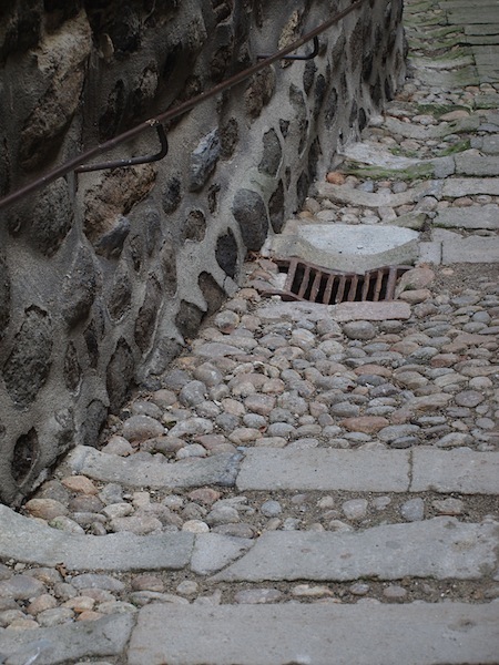 Cobblestone wall and pavement in Le-Puy, France. Cobblestones are water-worn beach or river stones and their shape enabled horse hooves to grip. 