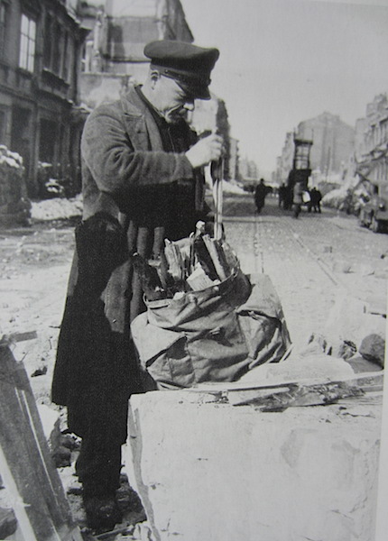 A man collecting firewood from the ruins, a verboten activity. Image from German Achives. 