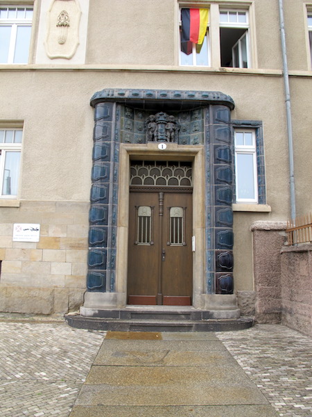 Ceramic tile door jambs, lintel and coat of arms. This would have had to be a one off. 