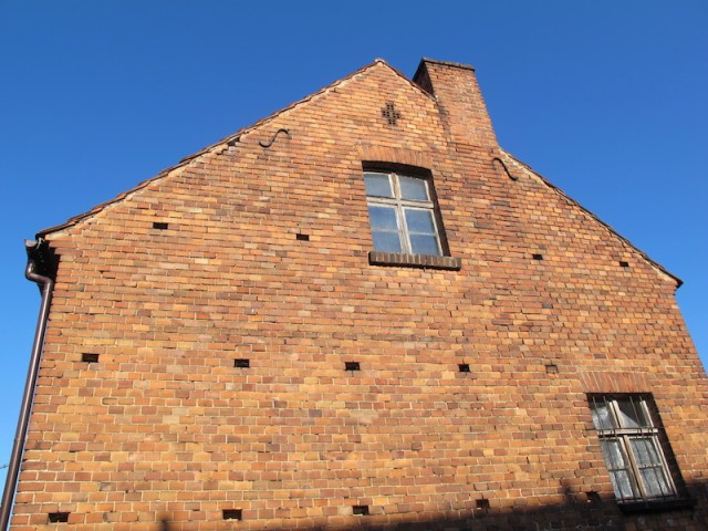 Gable end of the house. The holes in the wall were where timber scaffolding was placed during construction. 