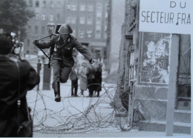  Conrad Schumann (1944-1988) an East German guard leaping the wire three days after it was erected. Image copyright Peter Leibing.