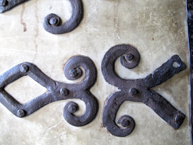 Hinges of a pigskin-covered door on the cathedral. In times when there were no wood stains and preservative coatings covering a wooden door with pigskin makes sense. 