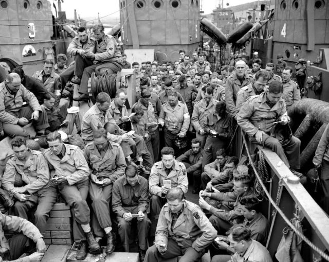 U.S. servicemen attend a Protestant service off the French coast aboard a landing craft before the D-Day invasion. Image credit: AP Photo/Pete Carroll from http://vcepinc.org