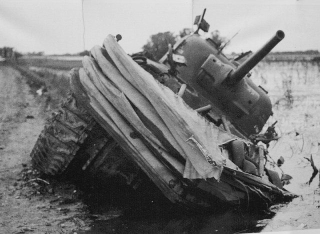 Bad news! An Allied tank in an embarrassing position on the edge of the marshlands. Image from open-air exhibition Utah beach. Photographer unknown 