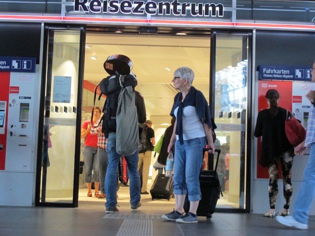 People watching outside the railway travel centre. Guitar where goes art thou and is Grandma going to visit her grandchildren? 