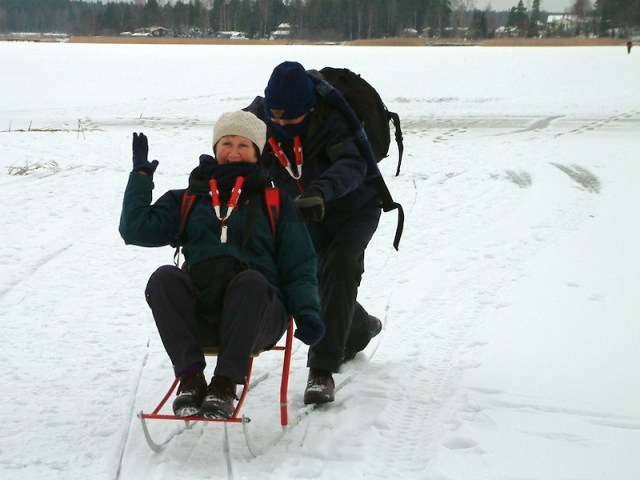 Pushing Bev across the lake in 2006. The obligatory ice picks are hanging around our necks. 