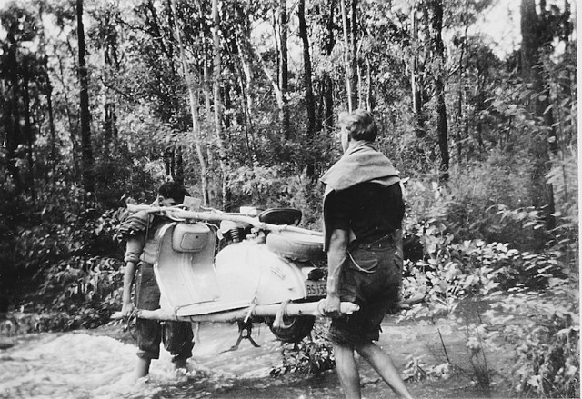 Carrying the Lambretta across a flooded creek. I may have the light end (the front) but I am walking backwards which was difficult! Image from John’s archives. 