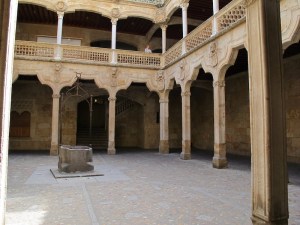 Within the biblioteca courtyard. Note the well in the middle and the intricate carved stone handrail.   