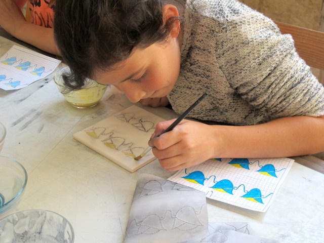 34 student decorating tile