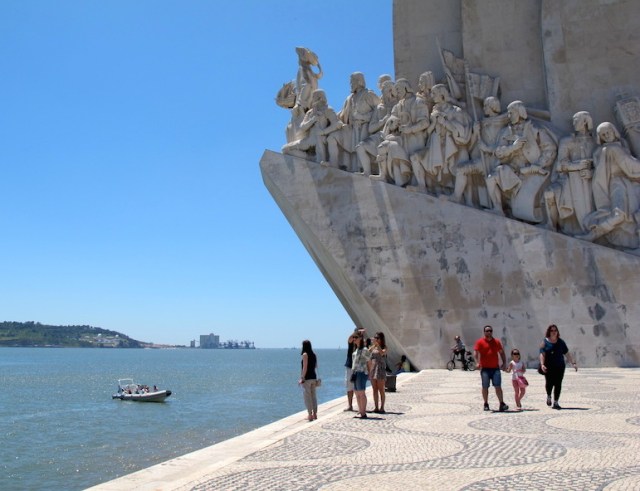 Portside of the Discoveries Monument. The figures are standing on a pedestal representing a ship’s bow. 