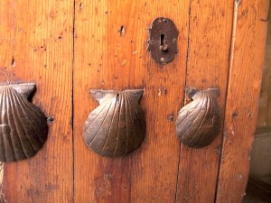   Scallop shell symbols on an old door.