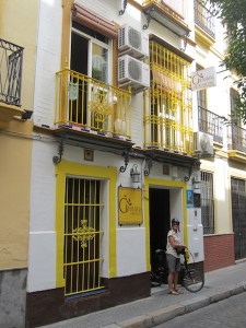 Bev ready for a day of exploring Seville. Our bedroom was on the lower floor to the left of the pension sign.
