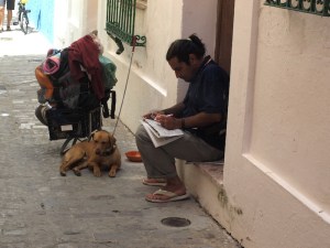 Doing the crossword in the backstreets of Tarifa.  This gentleman has the hallmarks of being homeless but he might just be a traveller who has accumulated too much stuff.   