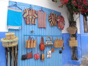 Colour is on the buildings, in the plants (bougainvillea) and goods for sale. 
