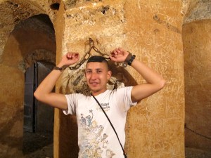 Omar demonstrating prisoner restraint in the dungeon of the Kasbah. 