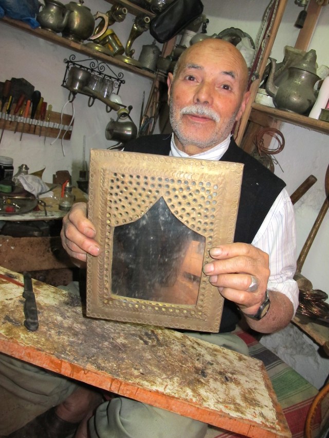 The creator of ornate frames. The mirror was not glass but polished stainless steel. 