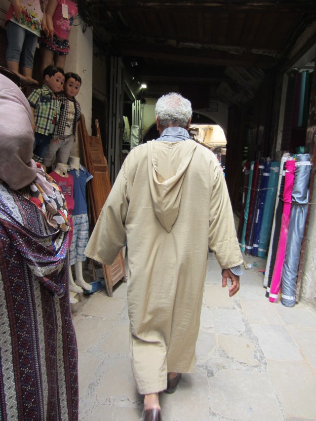 A rear view of a djellaba. Sometimes the hood is used as a pocket when in the down position, easy pickings for a pickpocket though. 