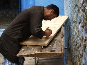 A carpenter making a door. 