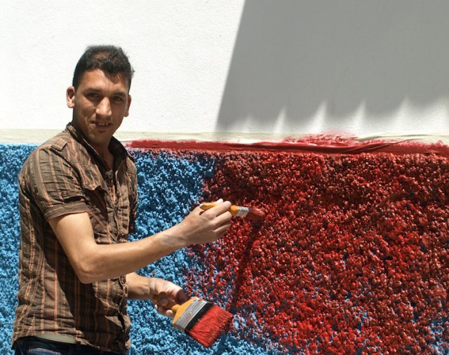 Blue to red. Painting this wall was going to be a long job as the surface was rough necessitating a lot of dabbing Ali found my concertina book amusing. 