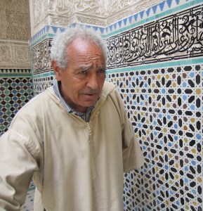 Our guide Abdul standing next to a Zelliga wall. 