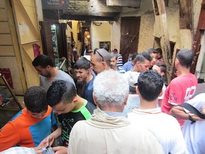 Moving into the mobile phone stalls of the market. The grey-haired man in the foreground is Abdul our guide 