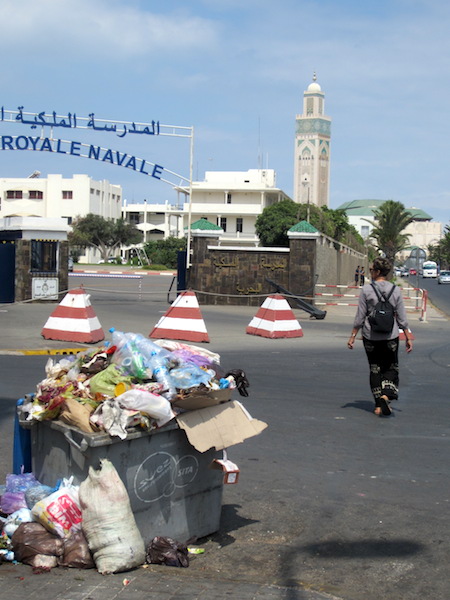 Bev passing by the Moroccan Royal Naval College on the way to the Hassan ll Mosque. The mosque minaret is in the distance. 
