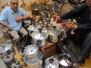 The pressure cooker and bits and bobs man. Enlarge this picture and take a close look at some of the stuff for sale. 