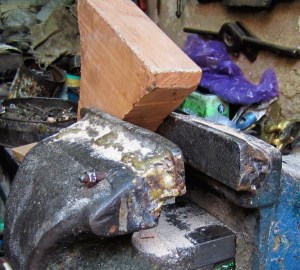 A vyce with a long history and a piece of wood that is going to be history. 