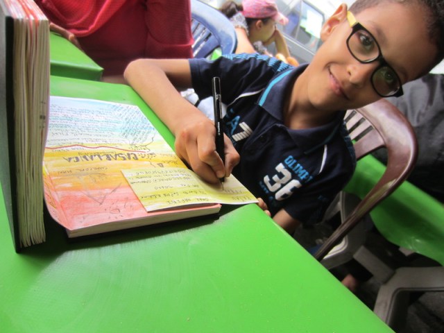 Rayan leaving a message in my concertina book. 