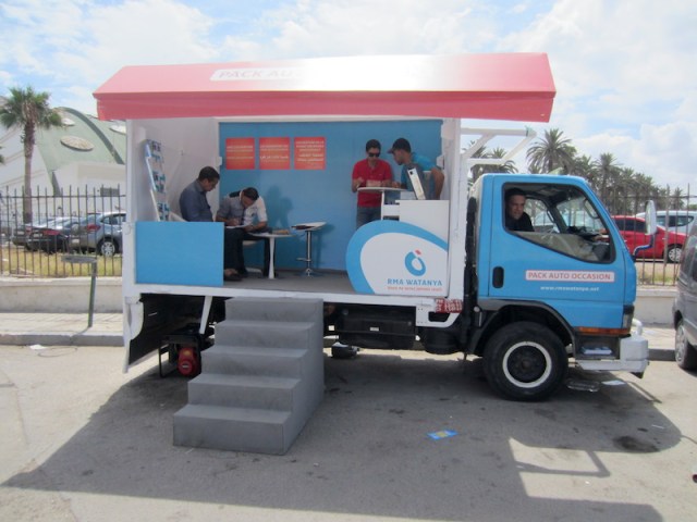 Exposed wires at the base of a power pole. 