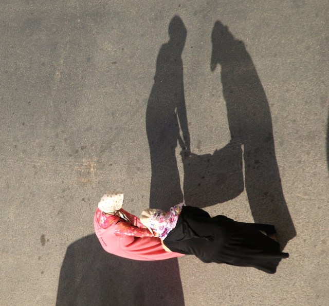 A couple of ladies struggling with their load.