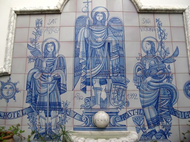 Saints looking over Hotel Maestre patrons in the Andalusian-style courtyard. 